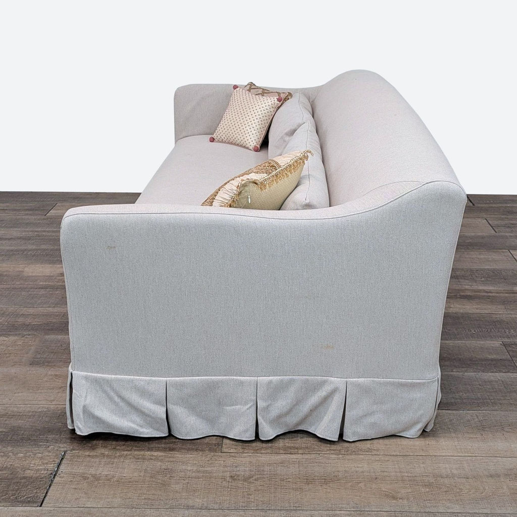 a [ unused0 ] sofa with a cream colored fabric