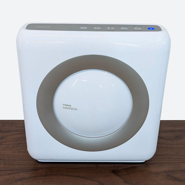 a white air purifier on a wooden table.
