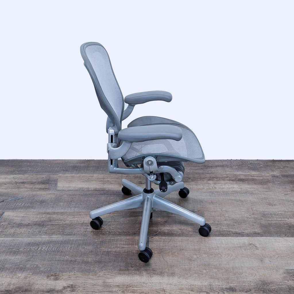 Side view of Herman Miller Aeron chair highlighting tilt function and ergonomic design.