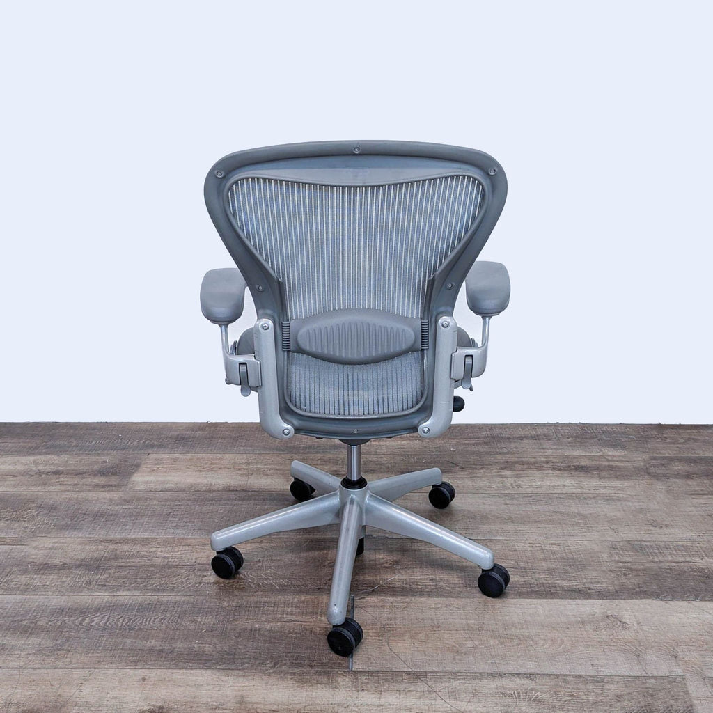 Rear view of Herman Miller Aeron chair displaying mesh back and adjustable features.