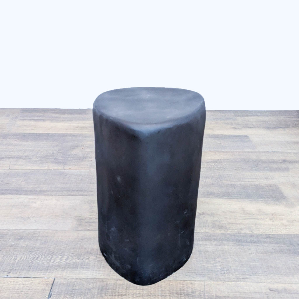 the stool is made of a black plastic with a black base.