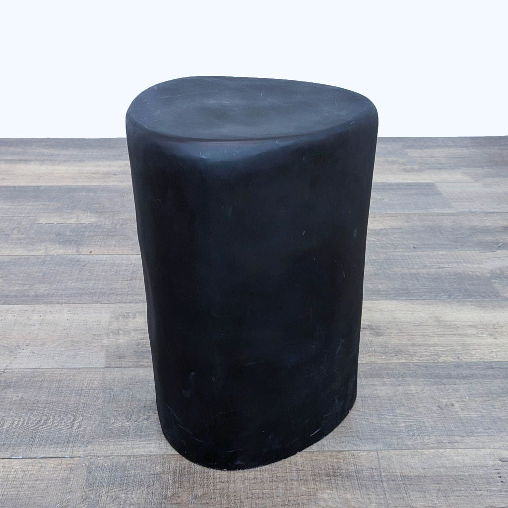 a black stool with a black leather seat.