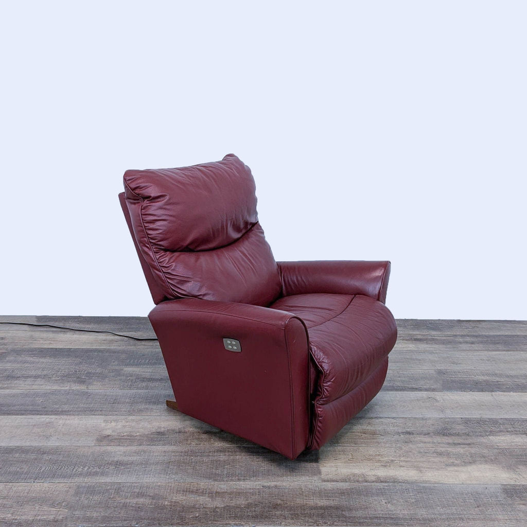 a red leather recliner chair with a recliner.