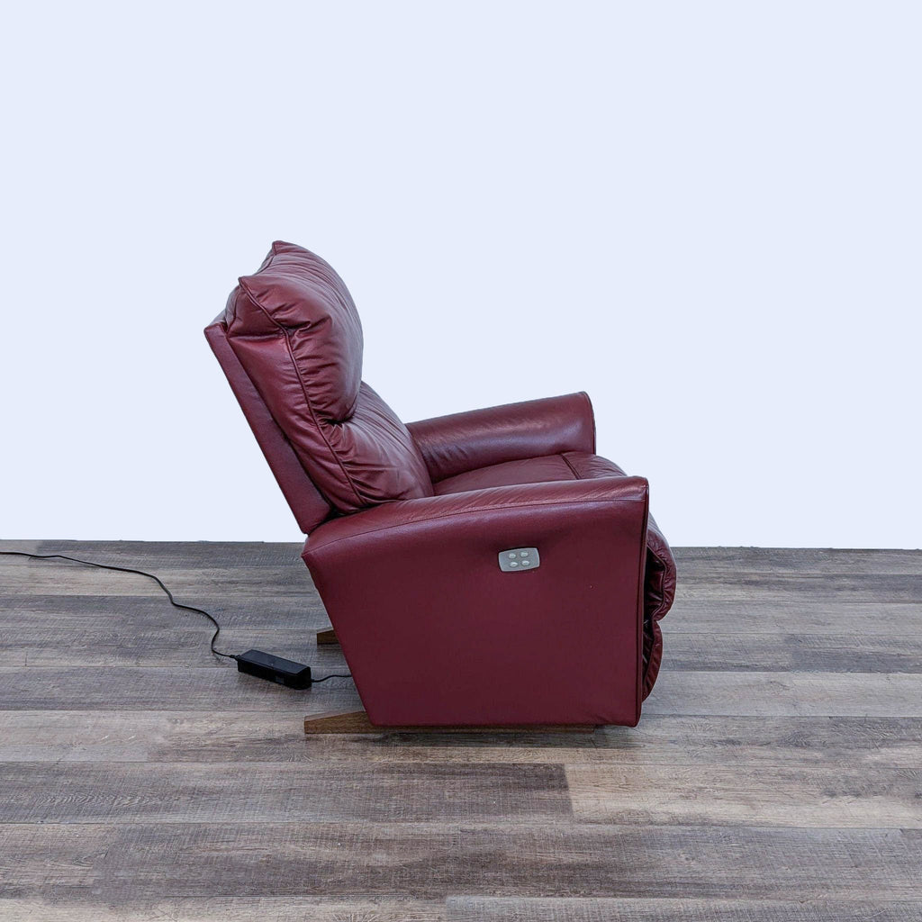 a red recliner chair with a power cord.