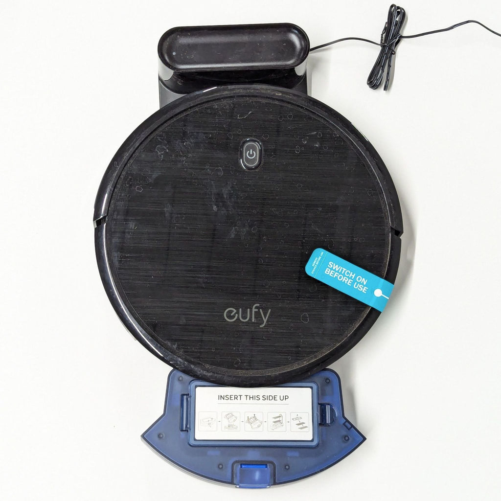 a blue and black speaker sitting on top of a white table.