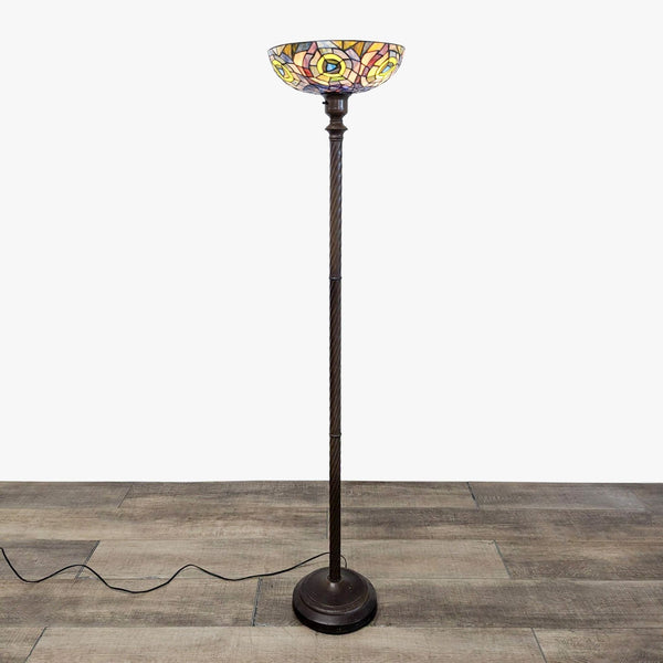 Reperch floor lamp with stained glass shade on wooden floor.