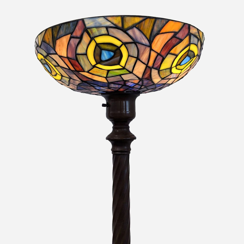 Close-up of stained glass lamp shade with colorful patterns.