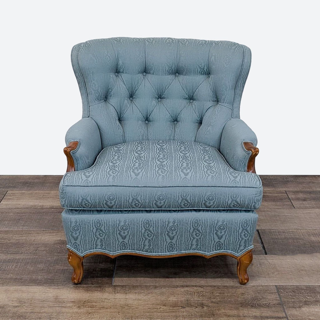 a blue velvet upholstered chair with a blue velvet upholstery.