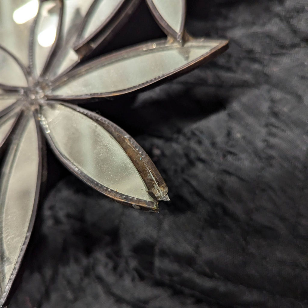 a silver and white flower brooch