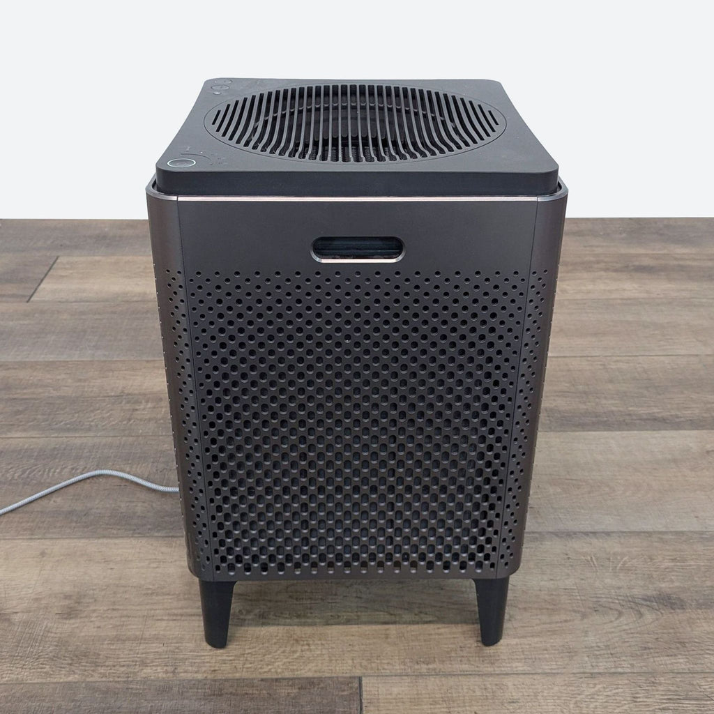 a small, portable, portable, and power supply unit on a wooden floor.