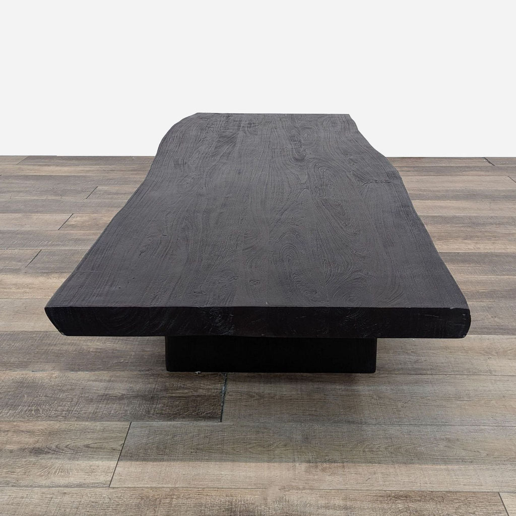 a large black coffee table with a large black base.