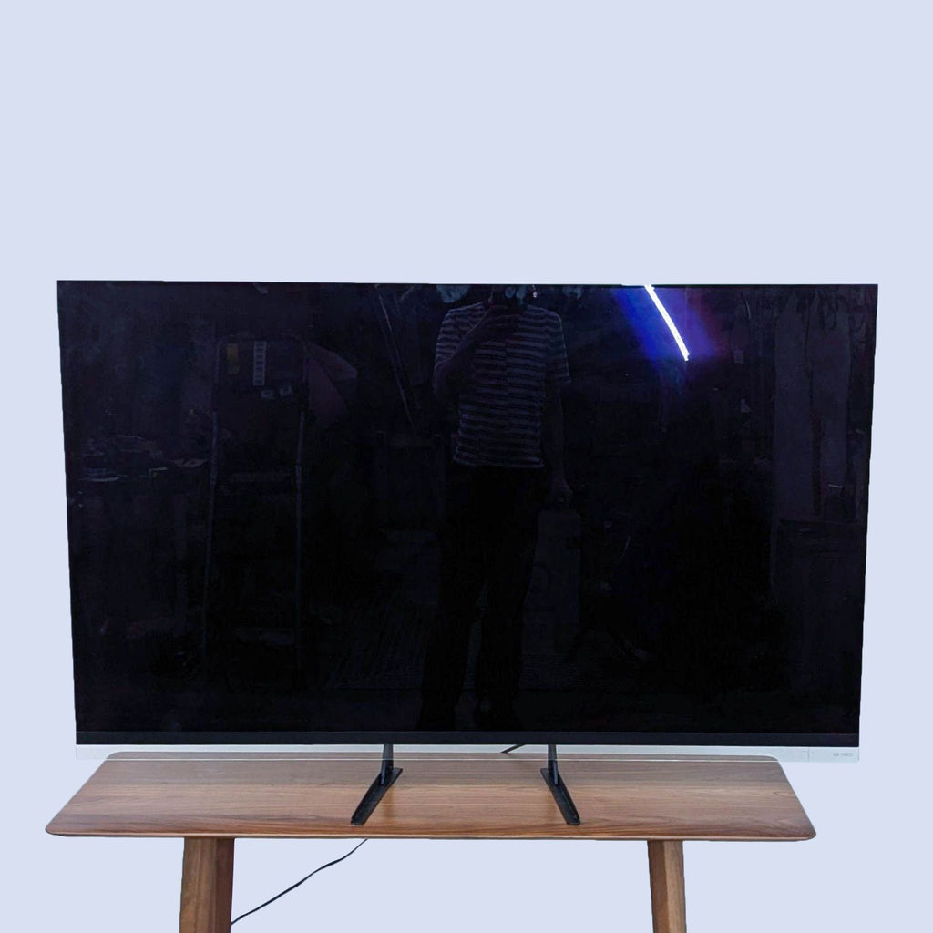 a tv on a wooden stand.