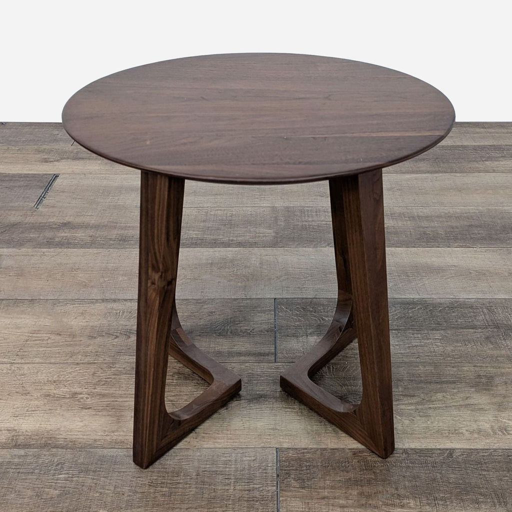 Reperch end table with rounded top and angular wooden legs.