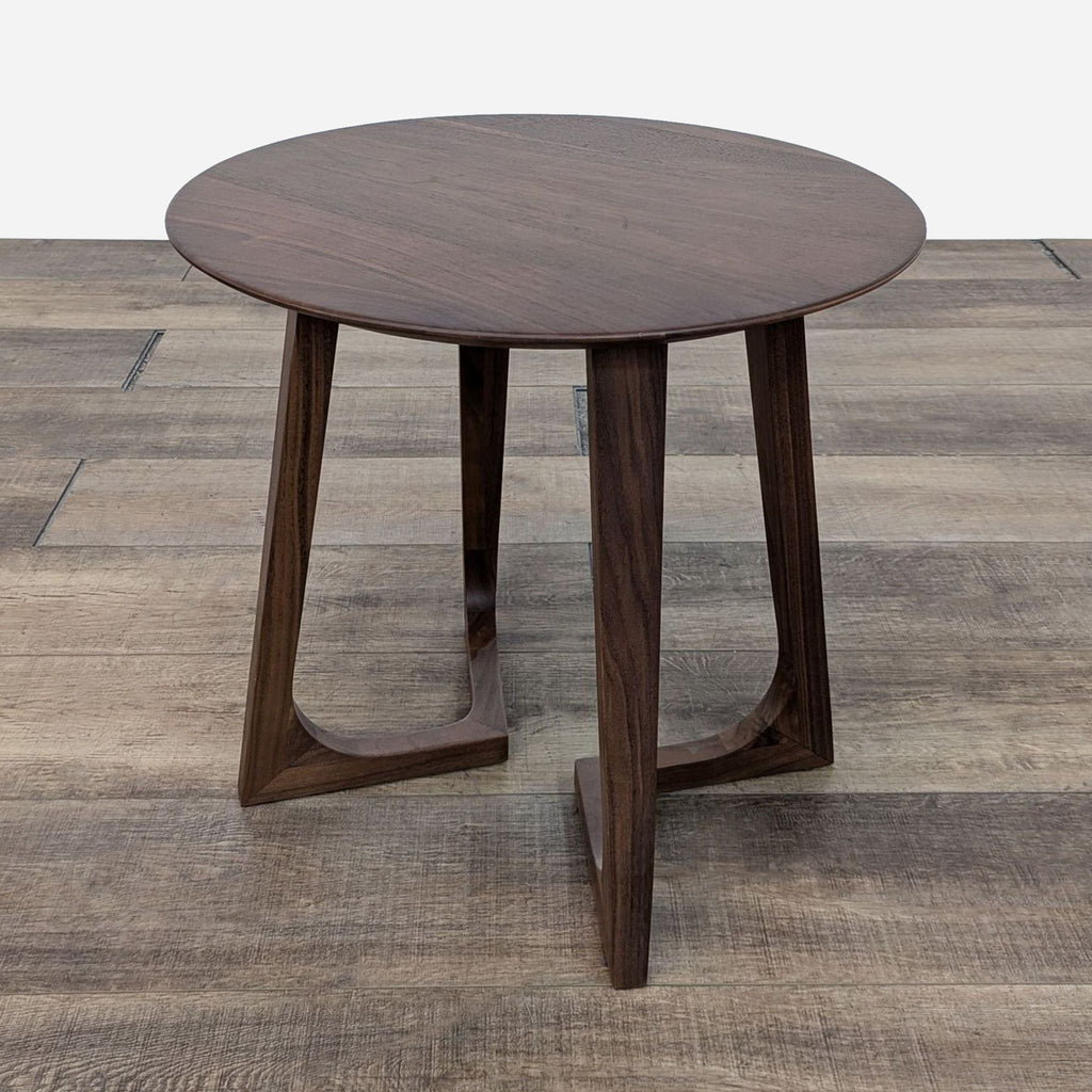 Minimalist Reperch end table with a round surface and geometric leg design.