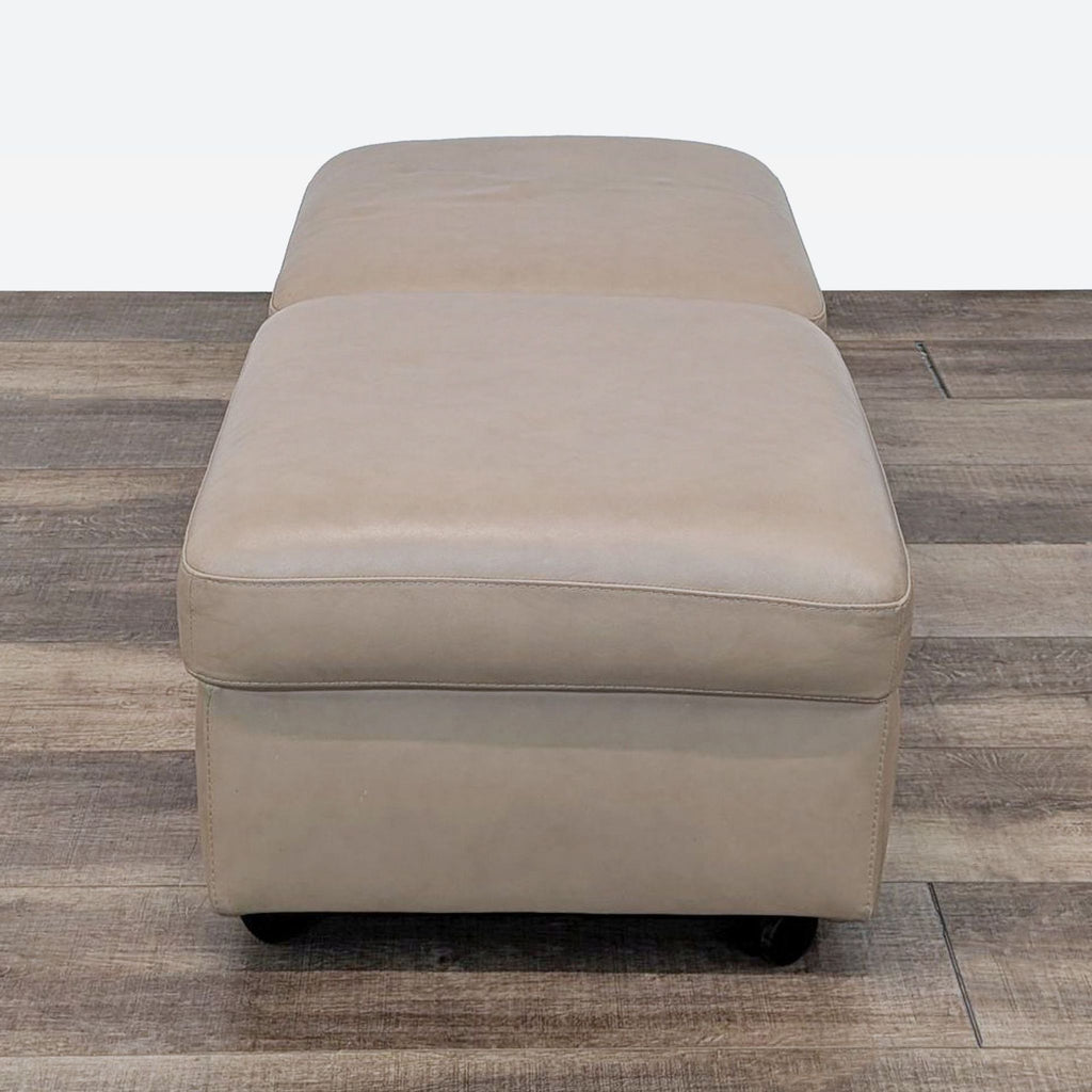 a leather ottoman with a footstool