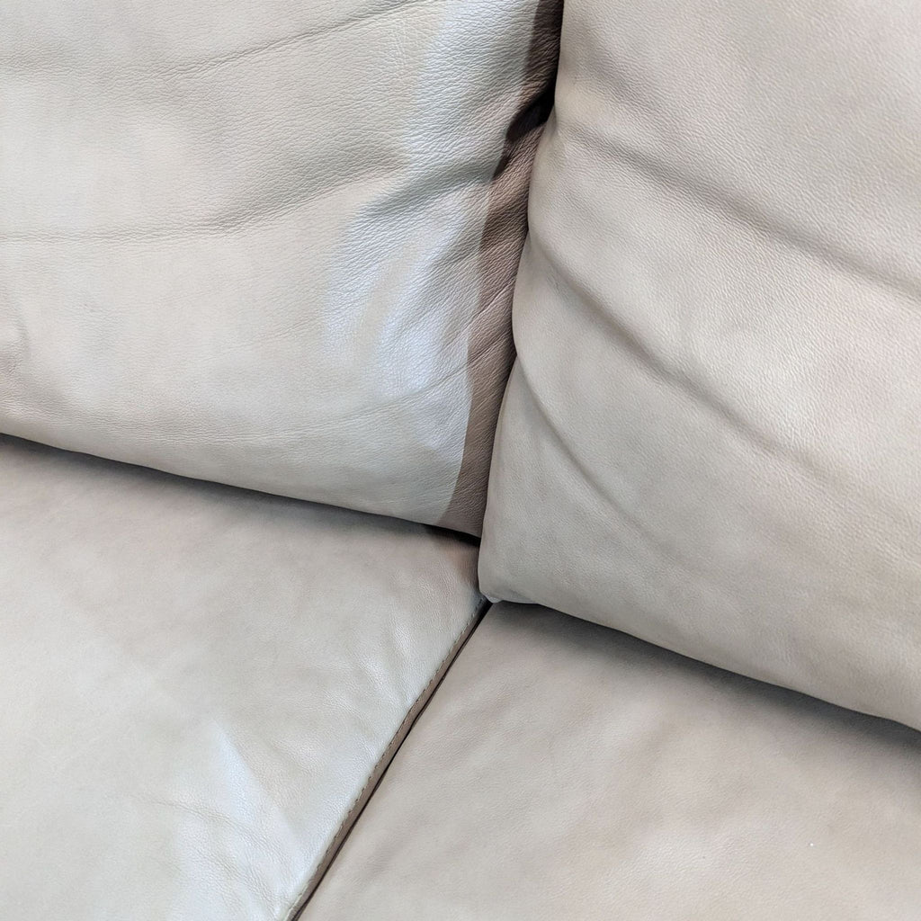 a close up of a white leather couch