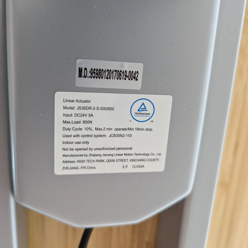 Close-up of the desk’s linear actuator label featuring specifications.