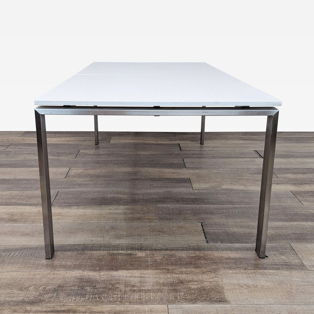 the table is a modern, minimalist design with a white surface.