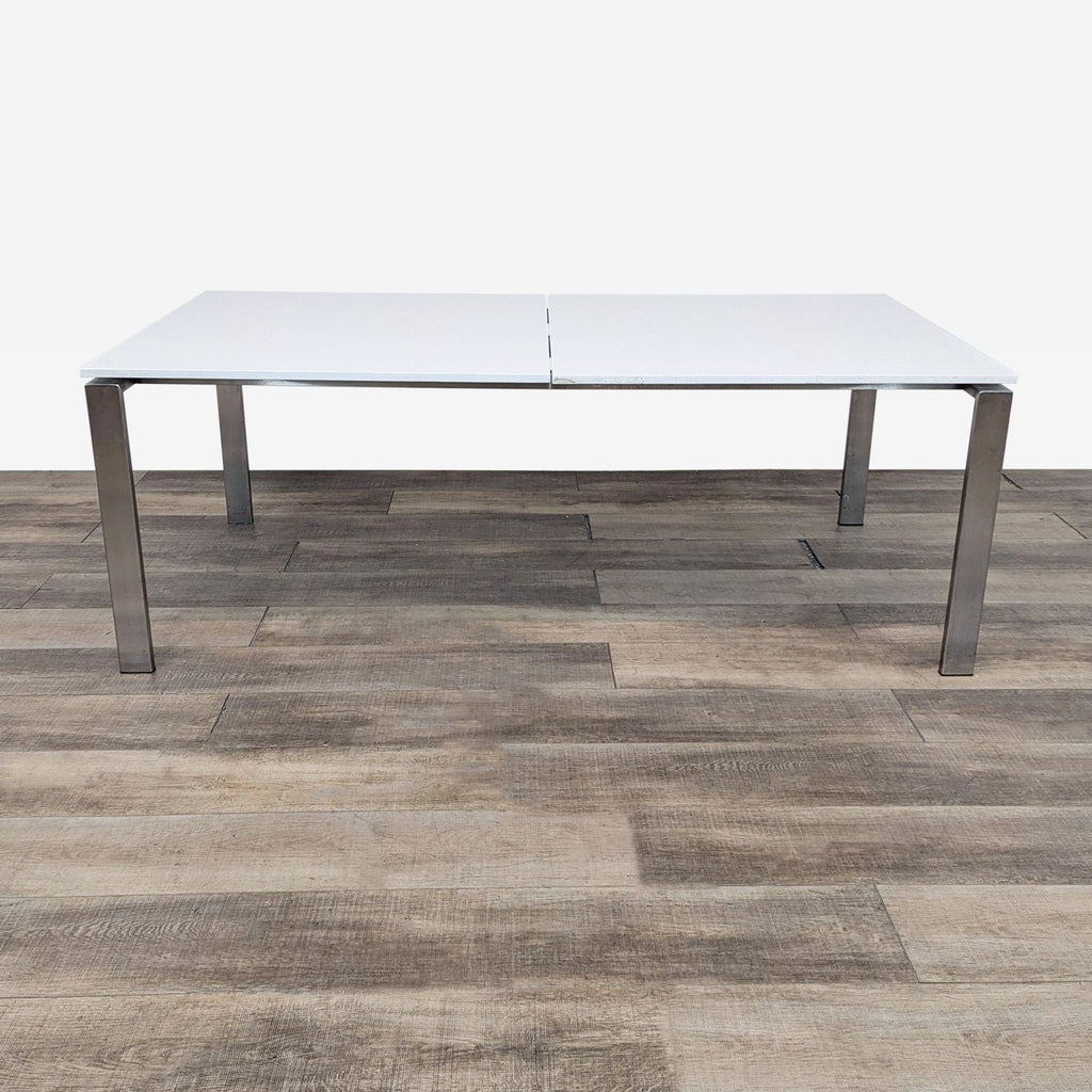 the table is a modern, minimalist design with a white surface.