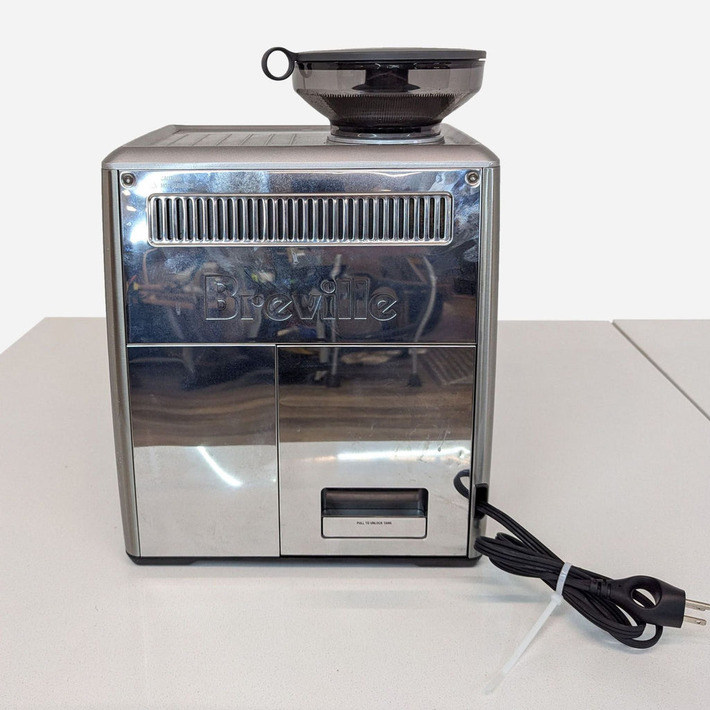 a stainless steel coffee machine with a coffee cup.