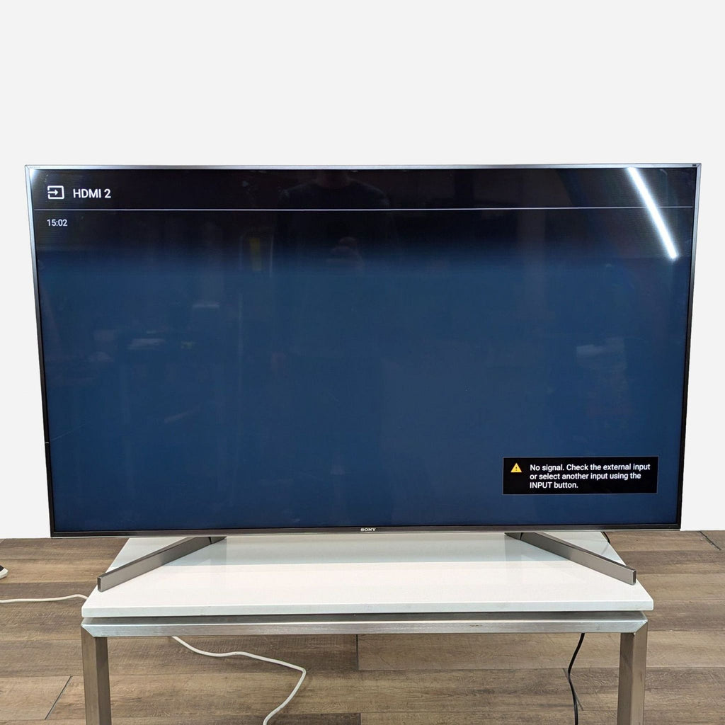 a large flat screen tv on a white table.