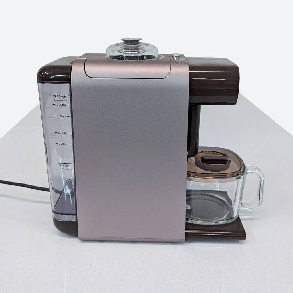 a coffee maker sitting on top of a white table.