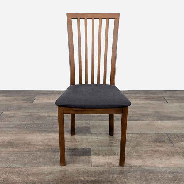 a wooden dining chair with a black seat and back.