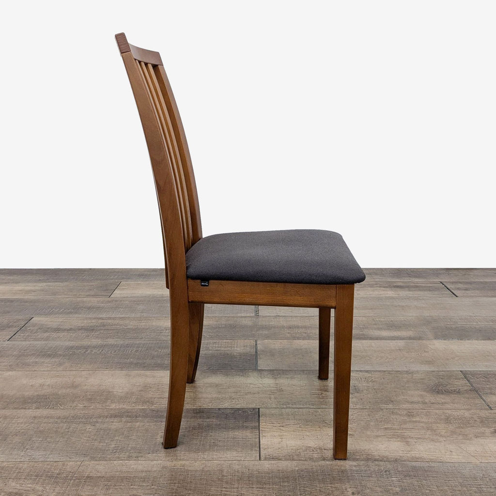 a modern dining chair with a gray cushion.