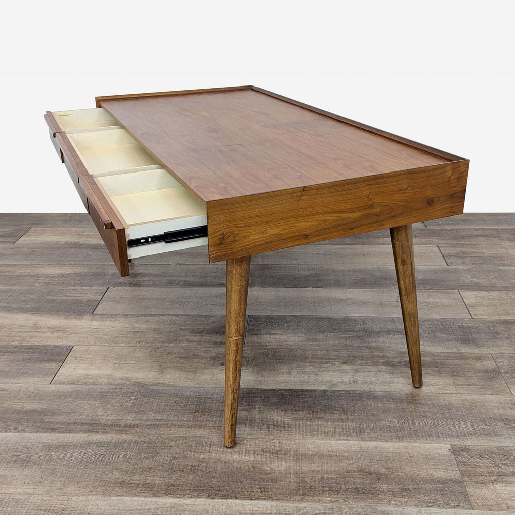 the coffee table is made from solid teak wood with a drawer open.