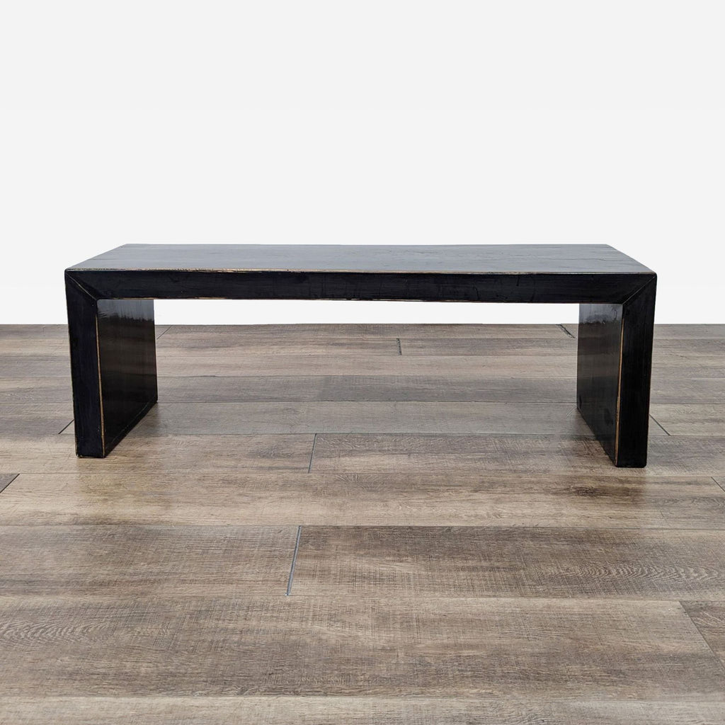 a black coffee table with a glass top.