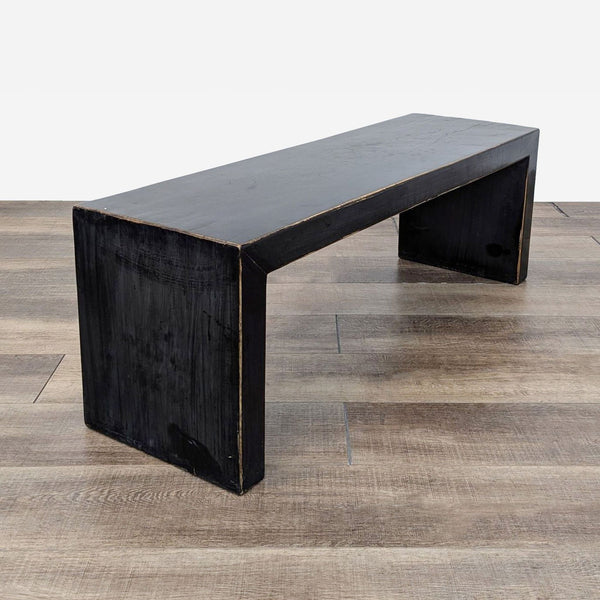 a black painted bench with a black finish.