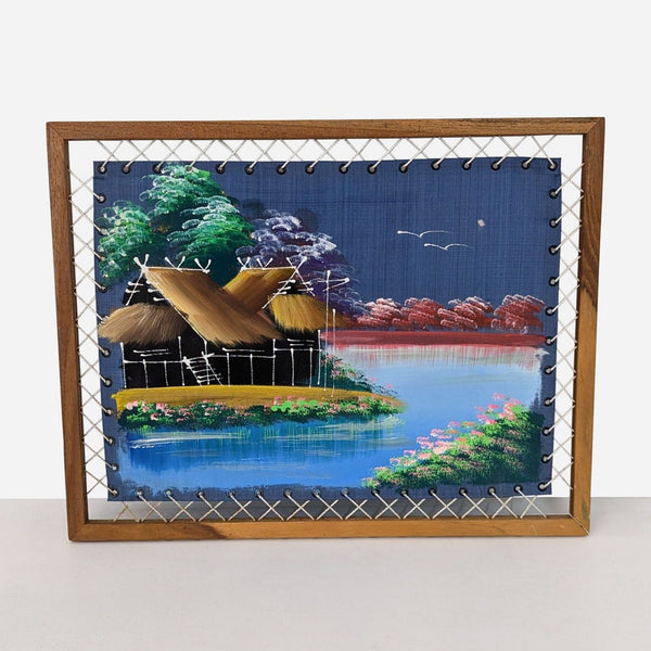 a framed painting of a village