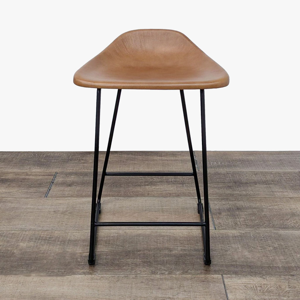 a leather bar stool with a leather seat.