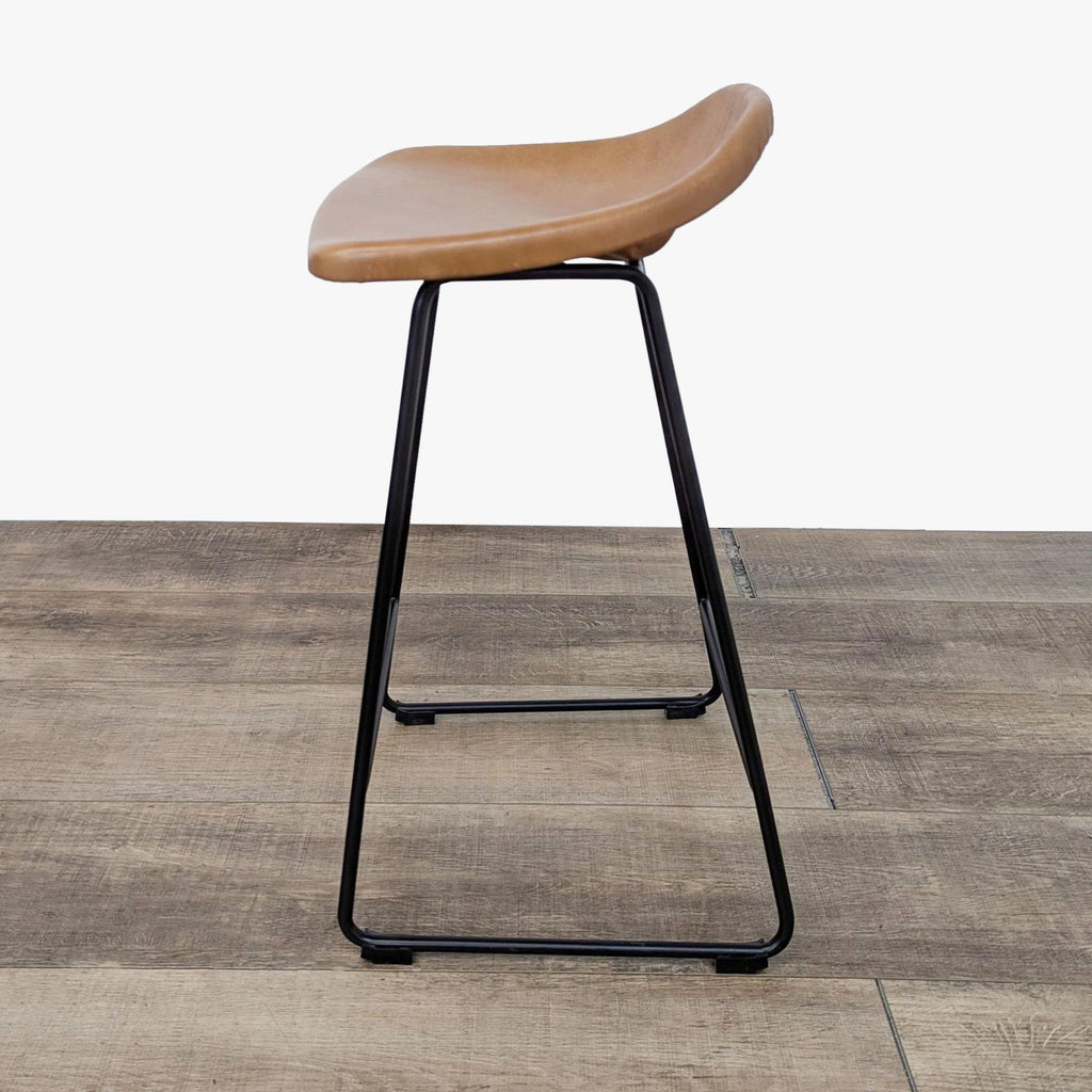 the bar stool is made from a leather seat and is made from a single piece of leather.