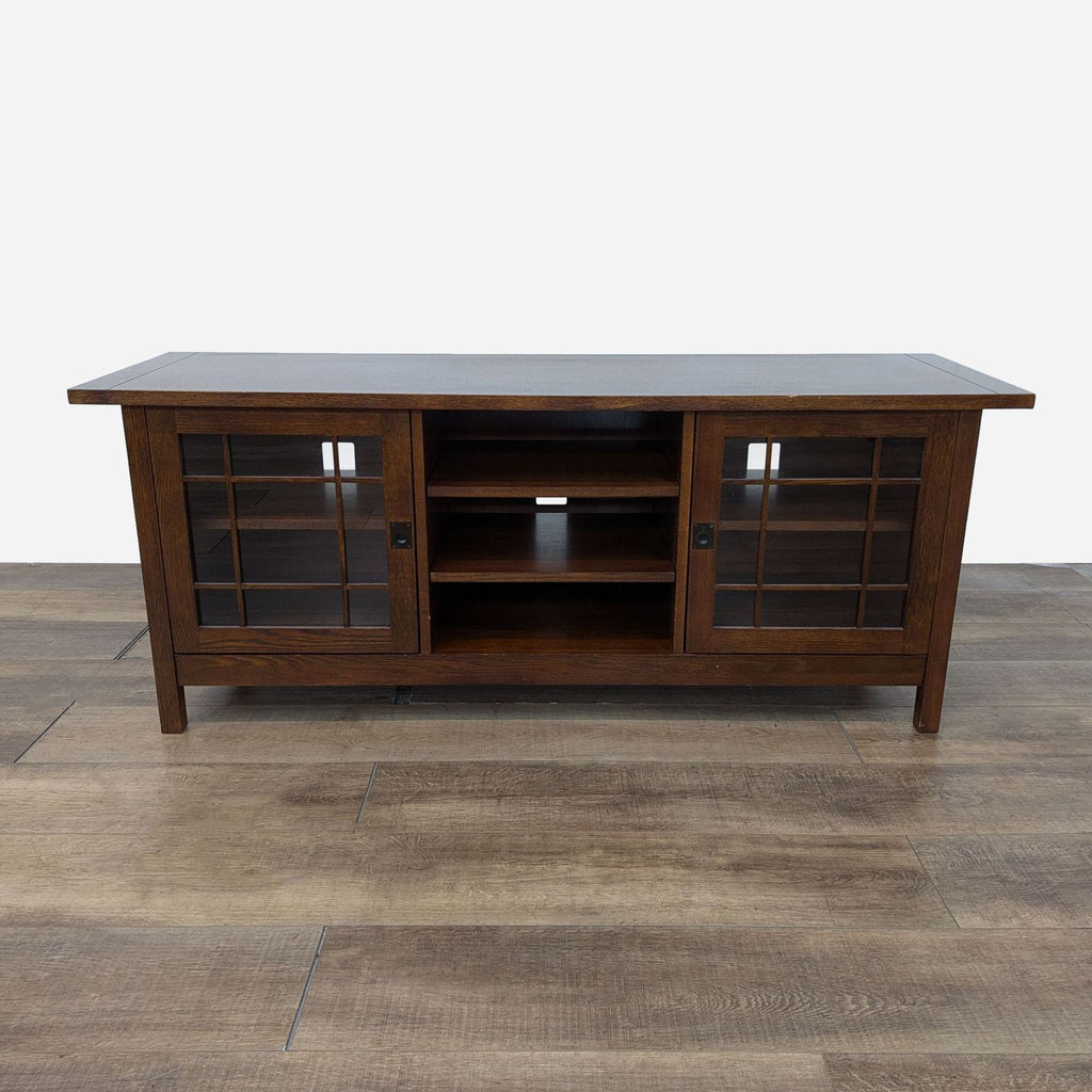 a walnut entertainment center with a glass shelf.