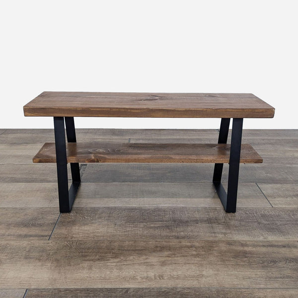 Console table by Reperch with dual shelves and black metal legs.