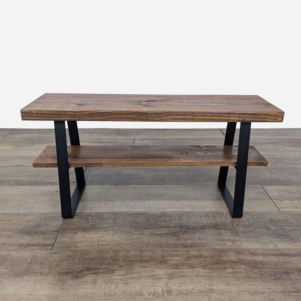 Reperch console table showcasing wooden shelves supported by black metal legs.