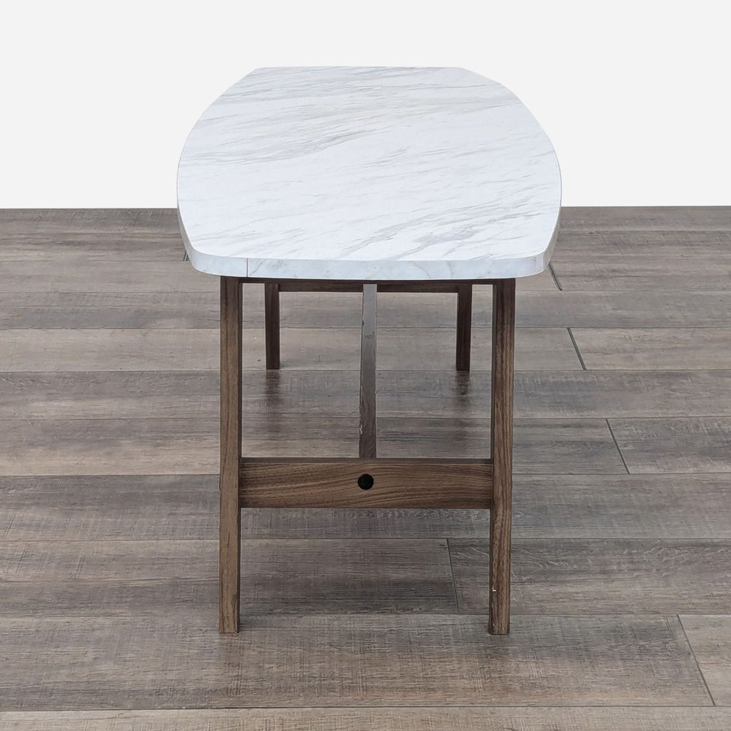 a marble table with a dark wood base