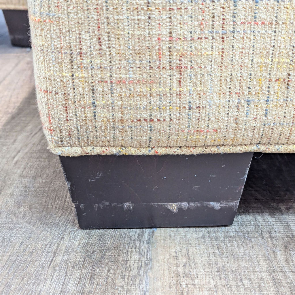 a close up of a chair with a wooden base.