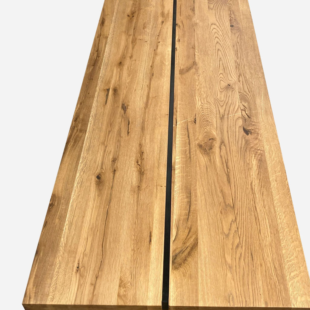 a close up of a long rectangular slab of solid wood with a black seam in the middle.