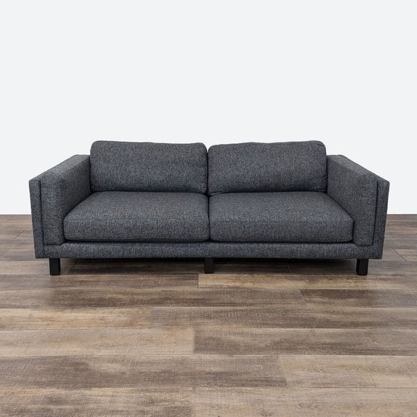 sofa is a modern sofa that is made from a dark grey fabric. the sofa is made from