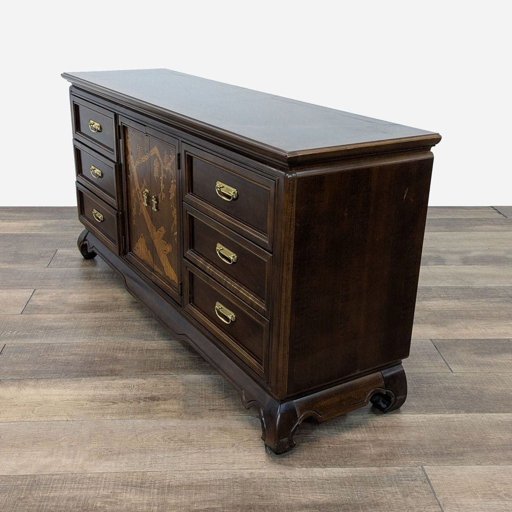 a large antique mahogany buffet with a drawer and a drawer.