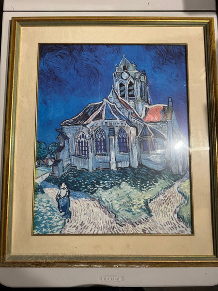1. Framed print of a church with vibrant blue sky and a path, inspired by Van Gogh’s painting, in gold frame.