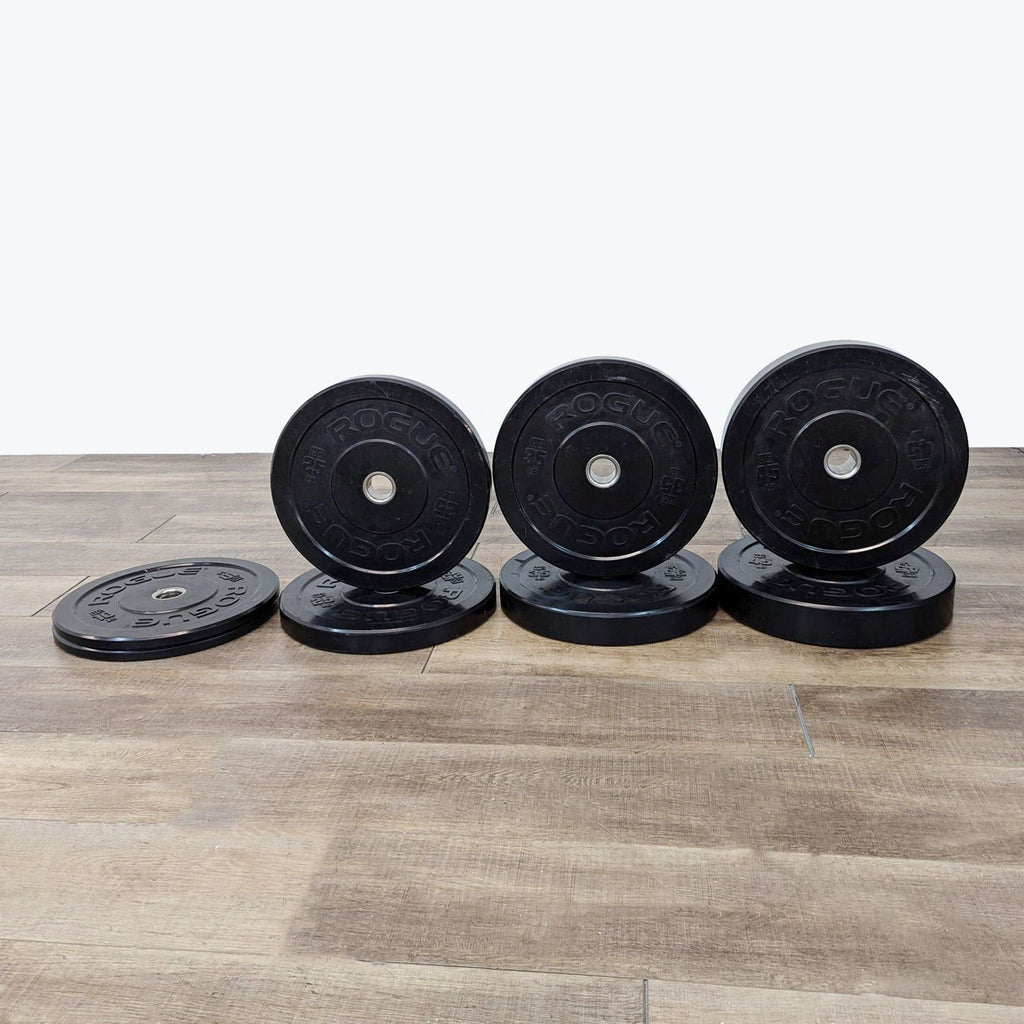 a stack of dumbbells on a wooden surface