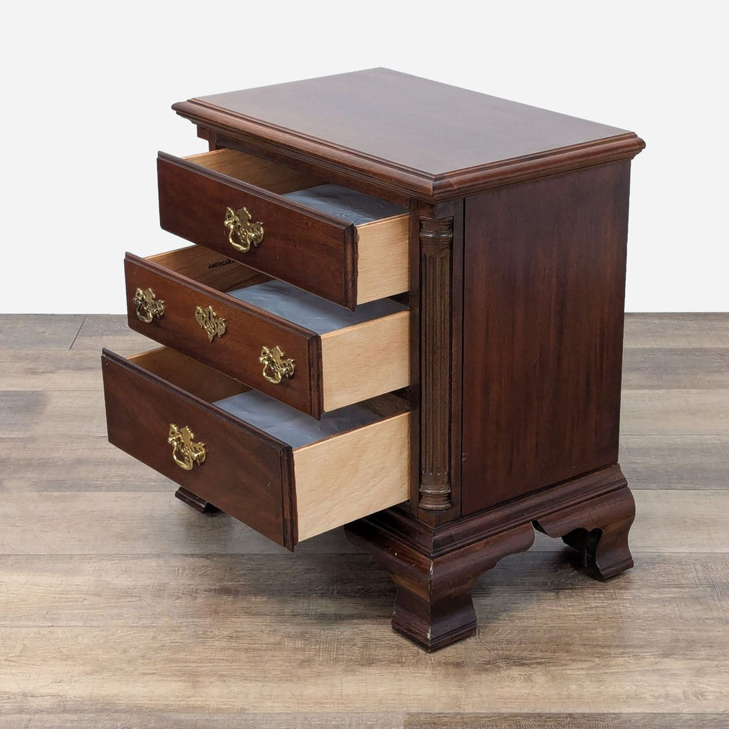 a small chest of drawers with a drawer.