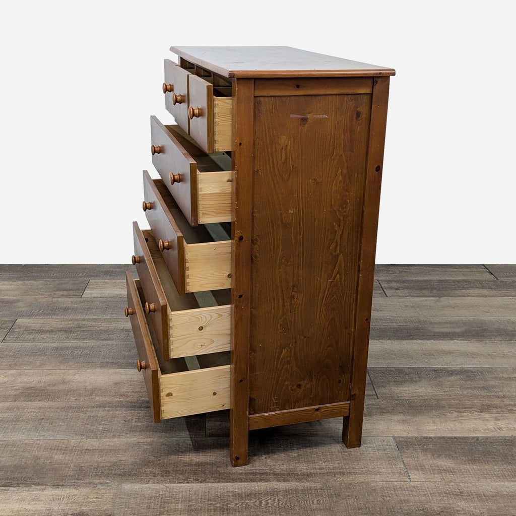 a tall, oak chest of drawers.