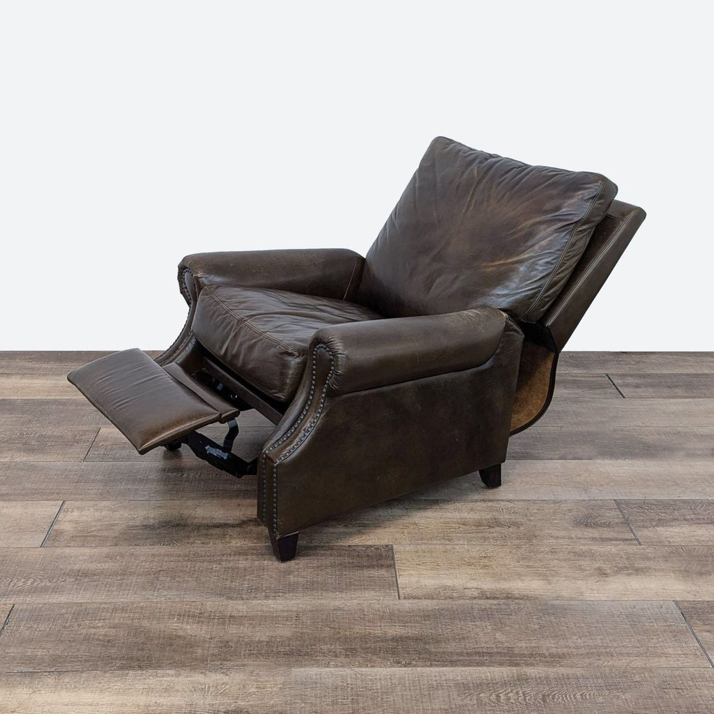 a leather recliner with a book and a foot rest.