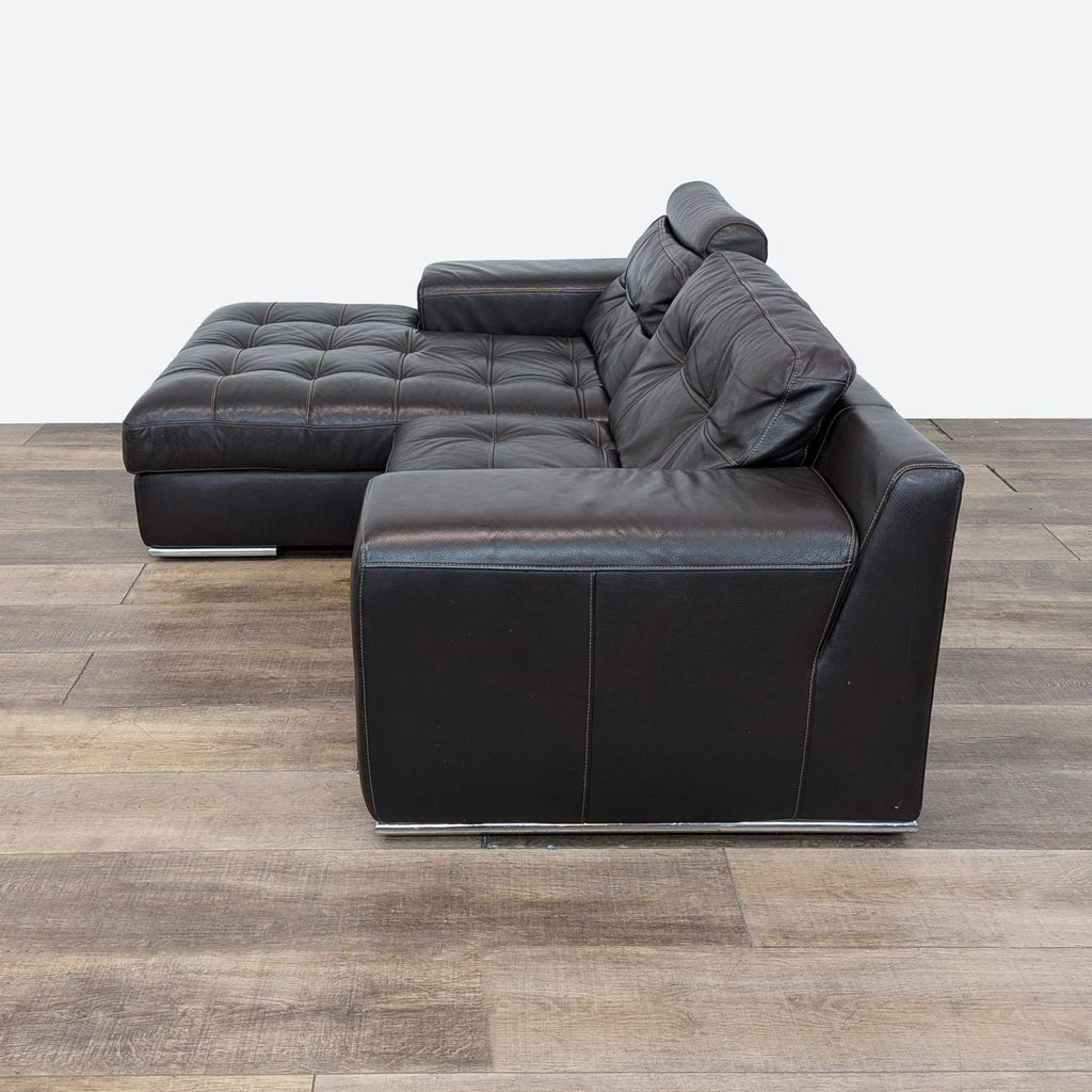 a leather sectional sofa with a black leather cover and a matching pillow.