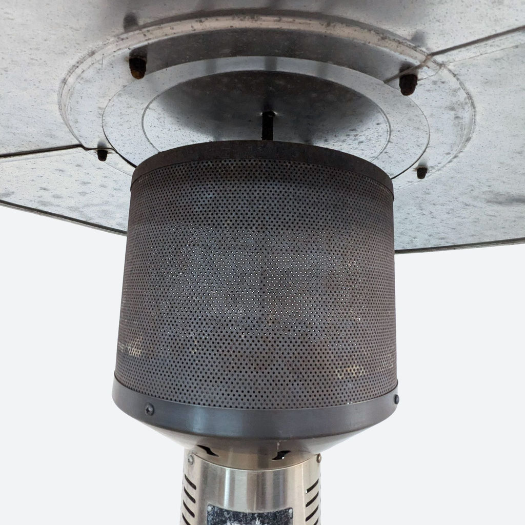 a close up of a metal vent on a metal base.