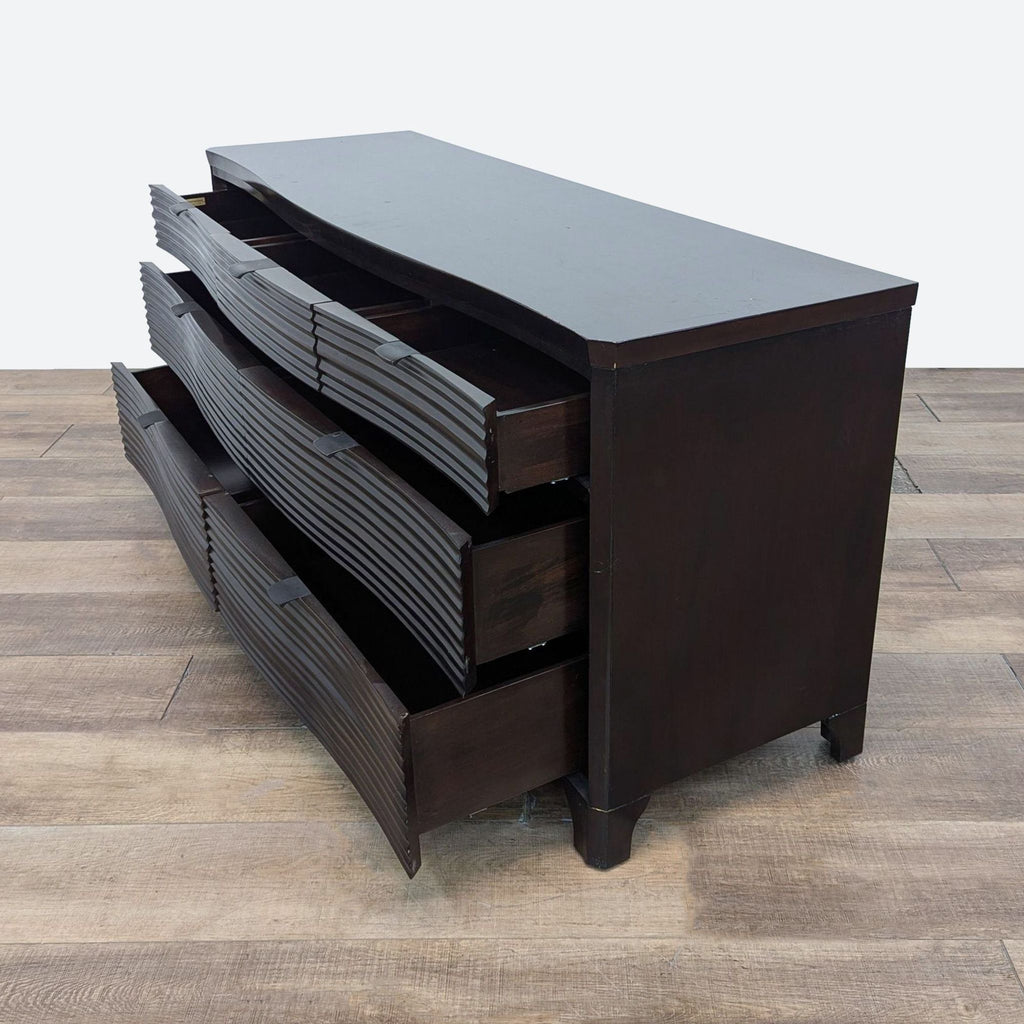 a large black wooden chest of drawers with three drawers.